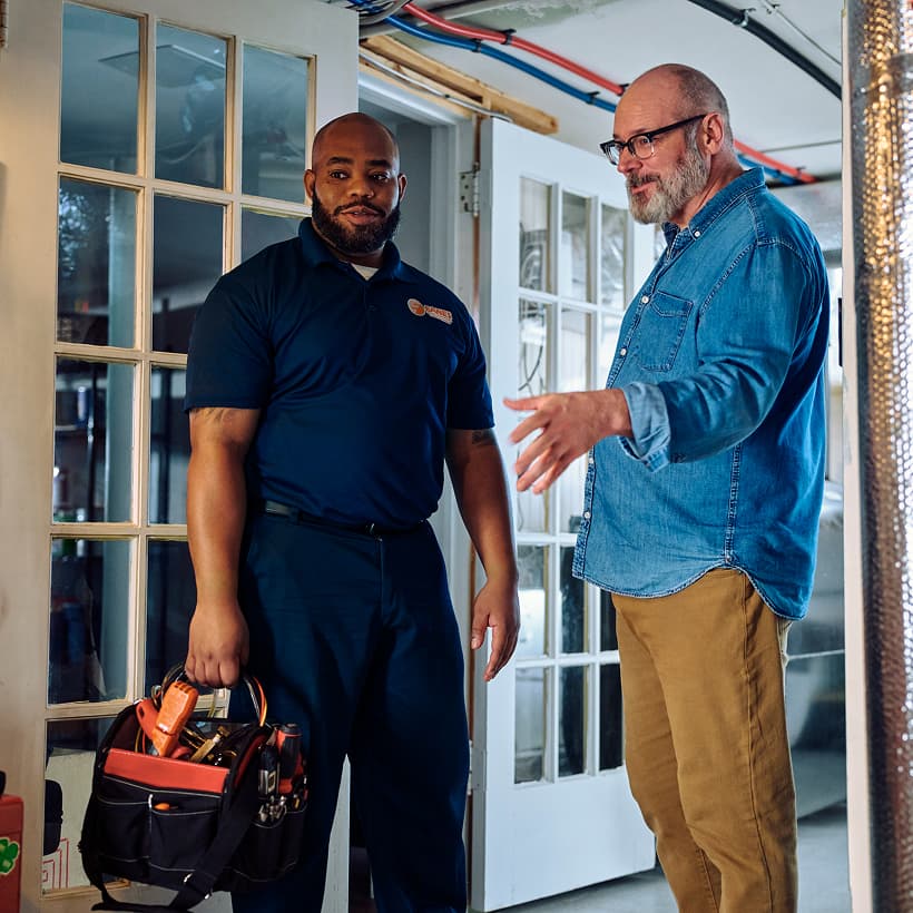 An Eanes technician discusses the repair and installation services with a homeowner.
