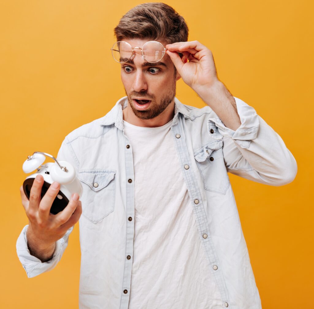 man holding a clock, worried about time